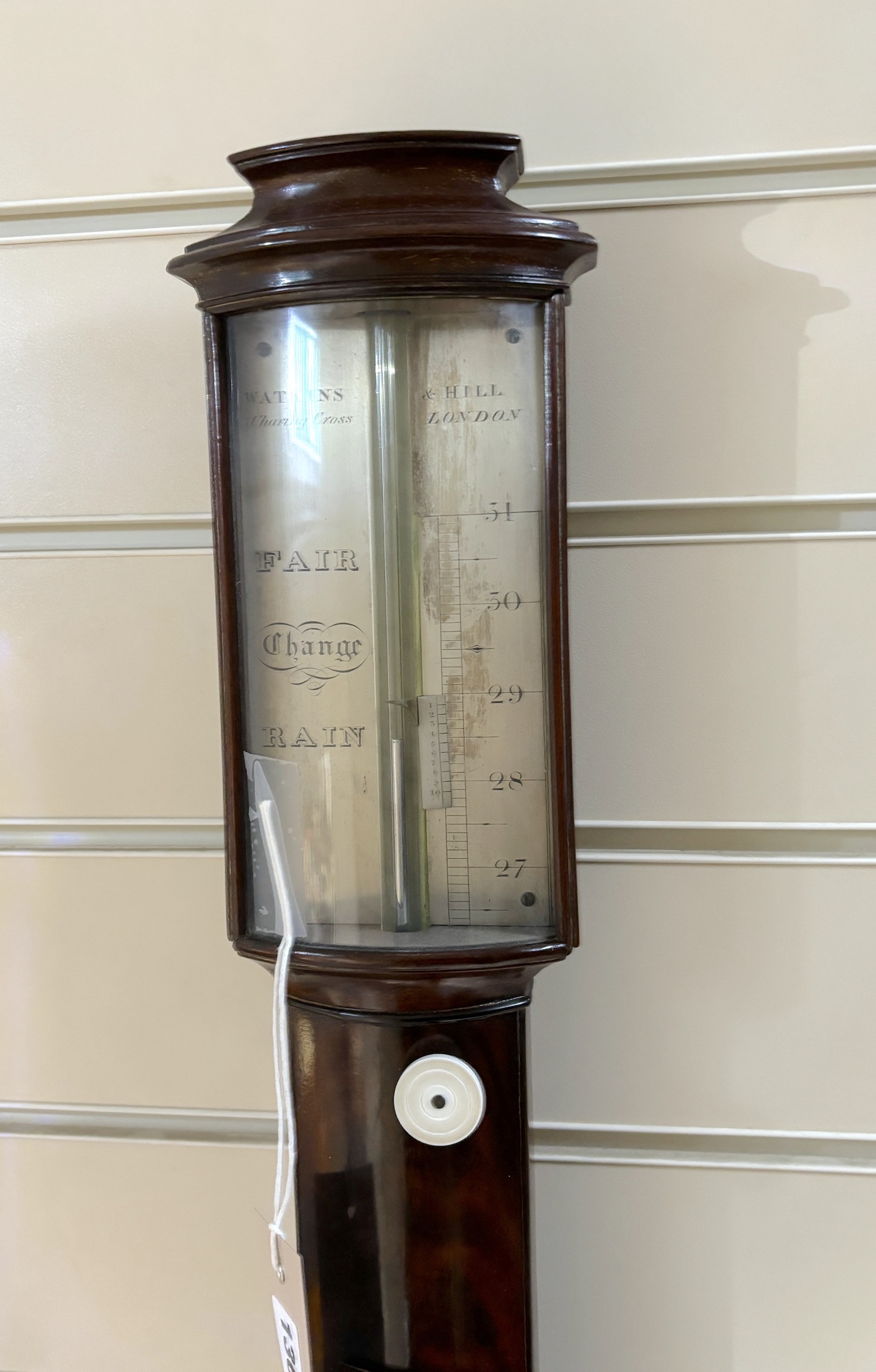 A 19th century mahogany stick barometer and thermometer by Watkins & Hill Charing Cross, London, with silvered scale, height 97cm